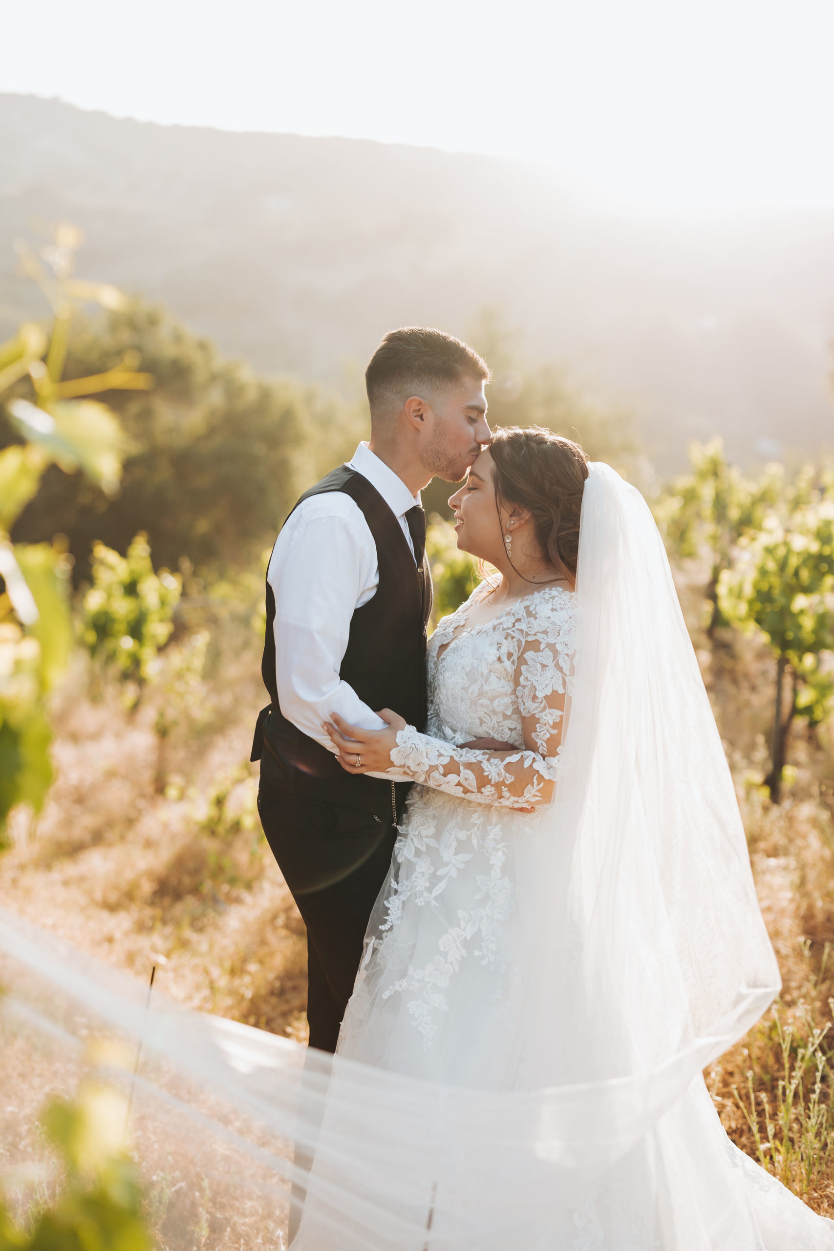 bride and groom kissing in Temecula 
 california vineyard