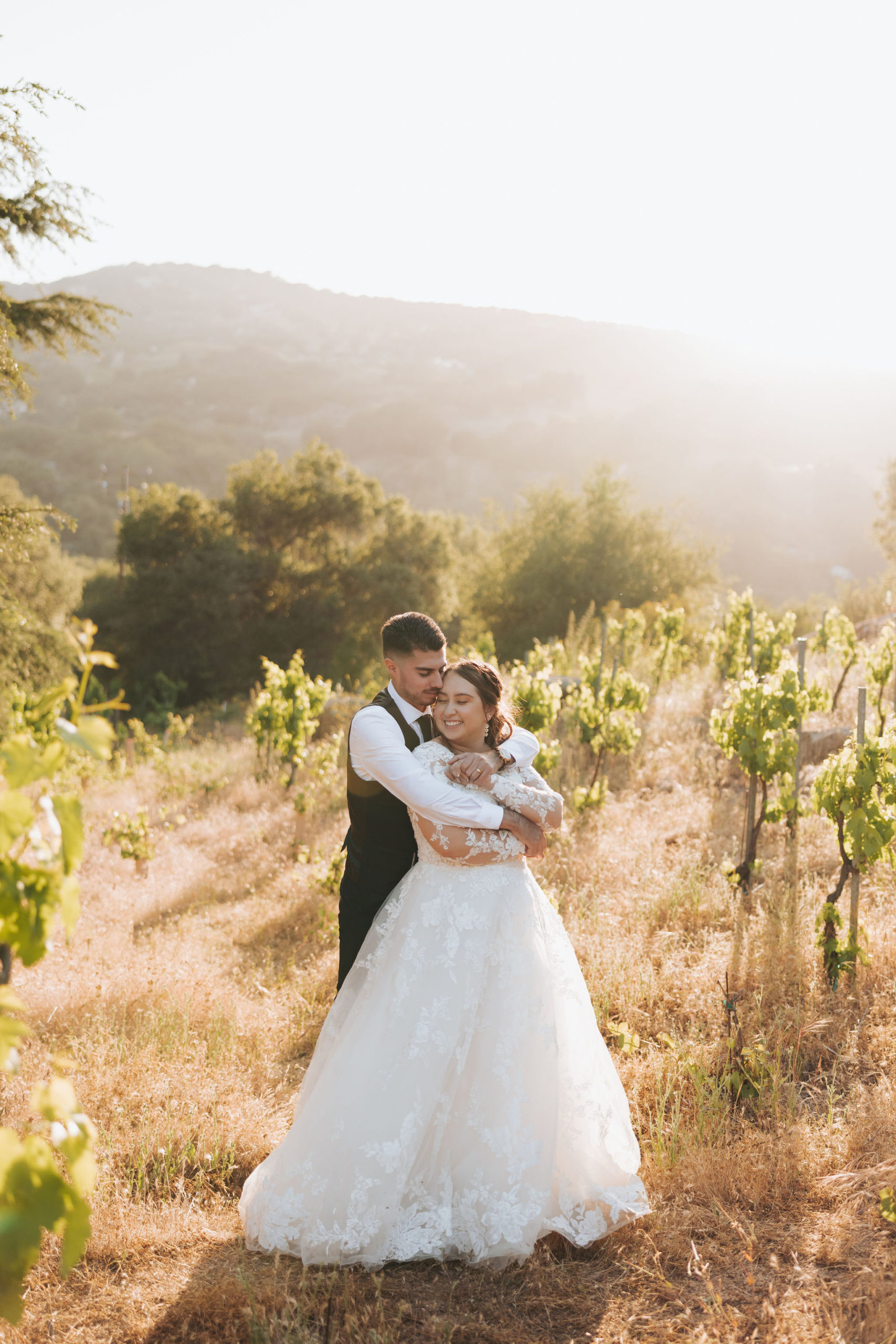 bride and groom hugging in Temecula 
 california vineyard
