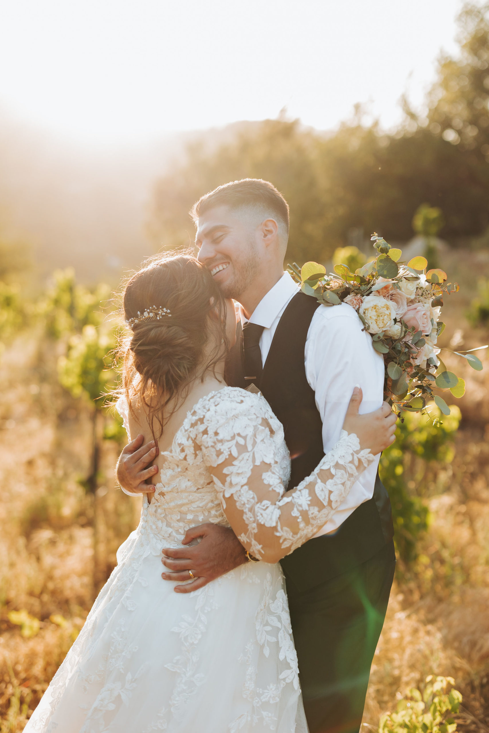 bride and groom hugging in Temecula california vineyard
