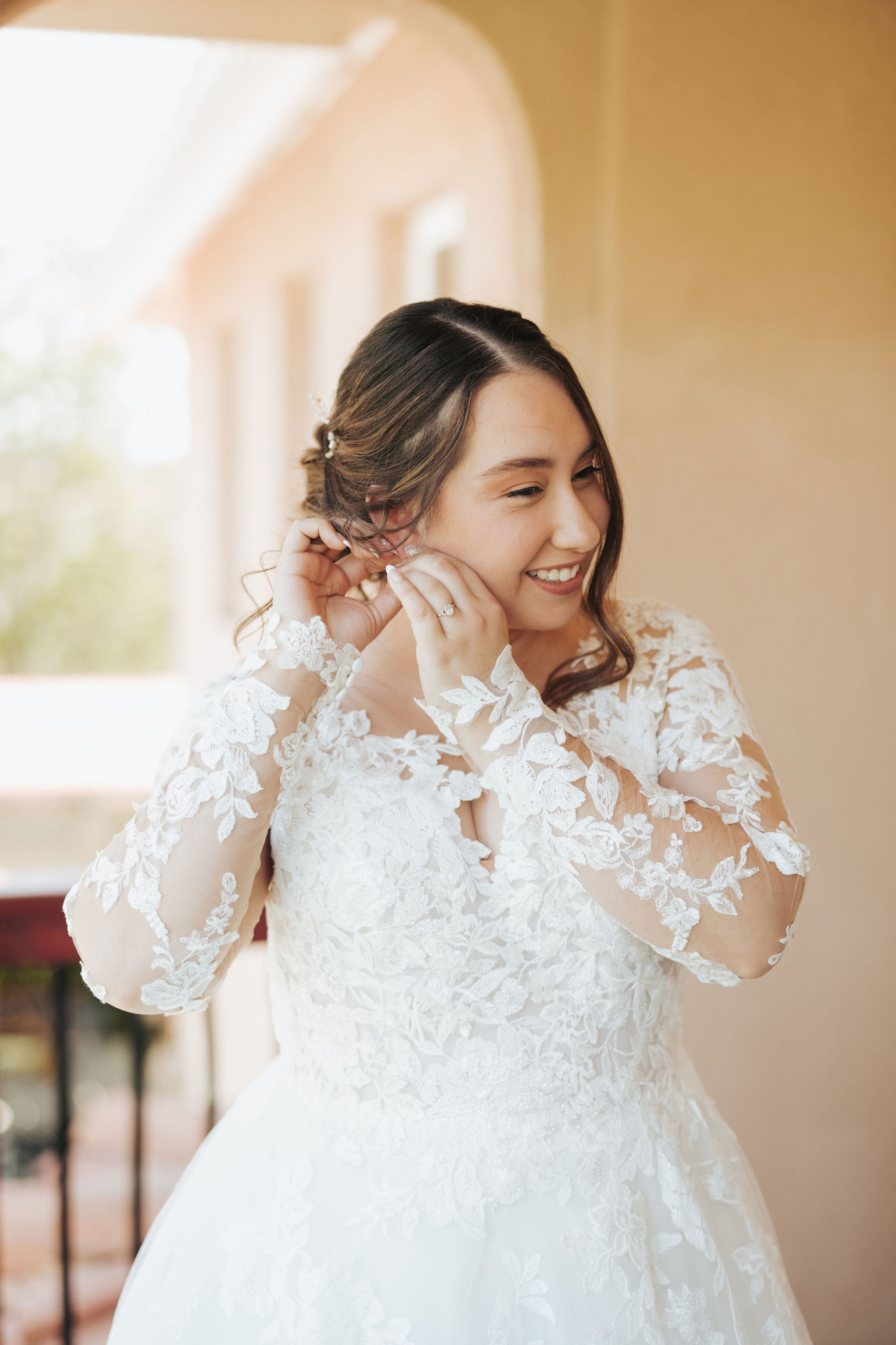 bride putting on her earring in Temecula 