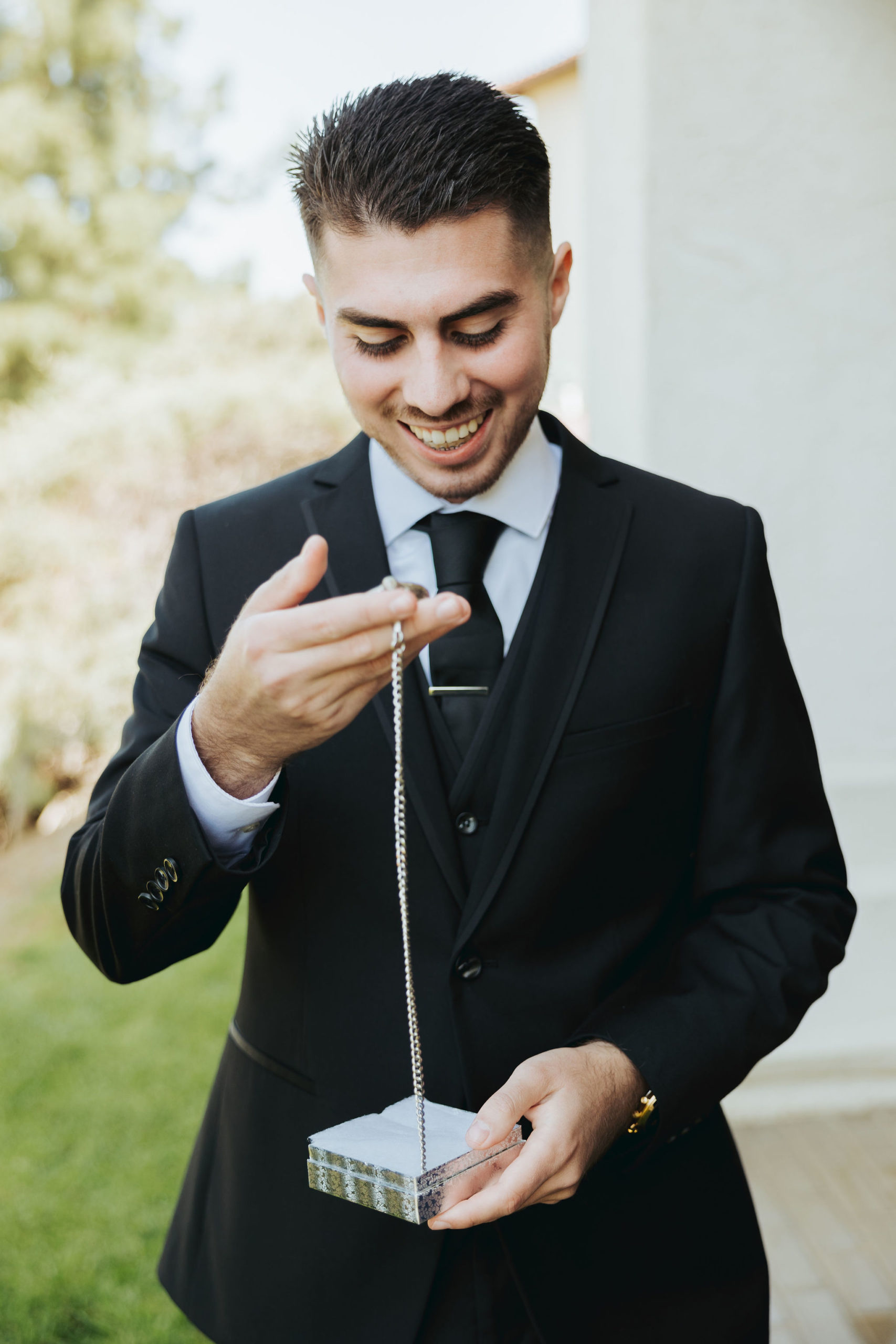 groom holding a pocket watch before wedding ceremony in temecula california