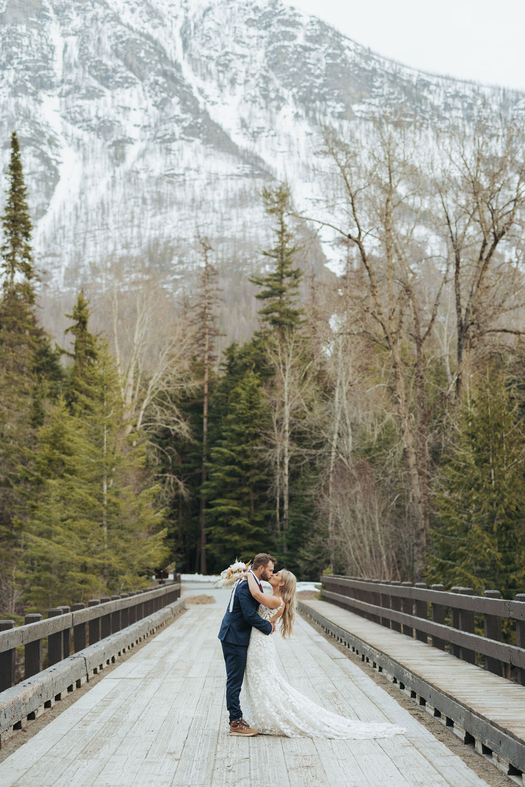 bride and groom portraits at glacier national park in front of mountains