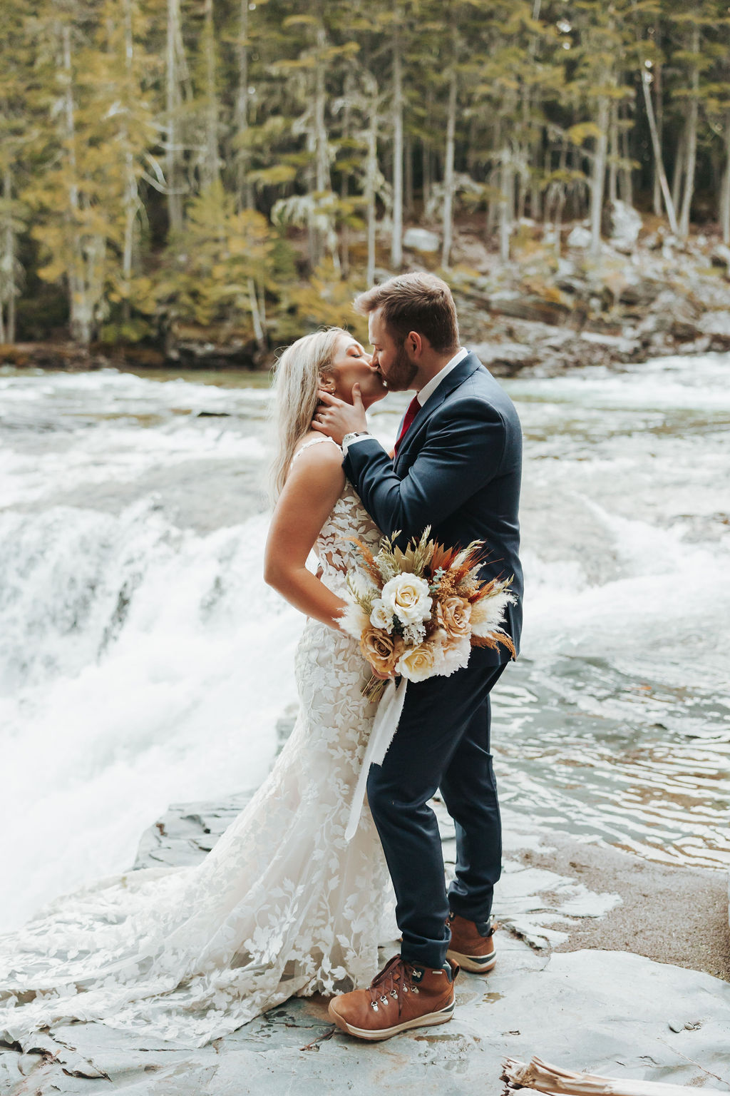 bride and groom portraits at glacier national park in waterfall