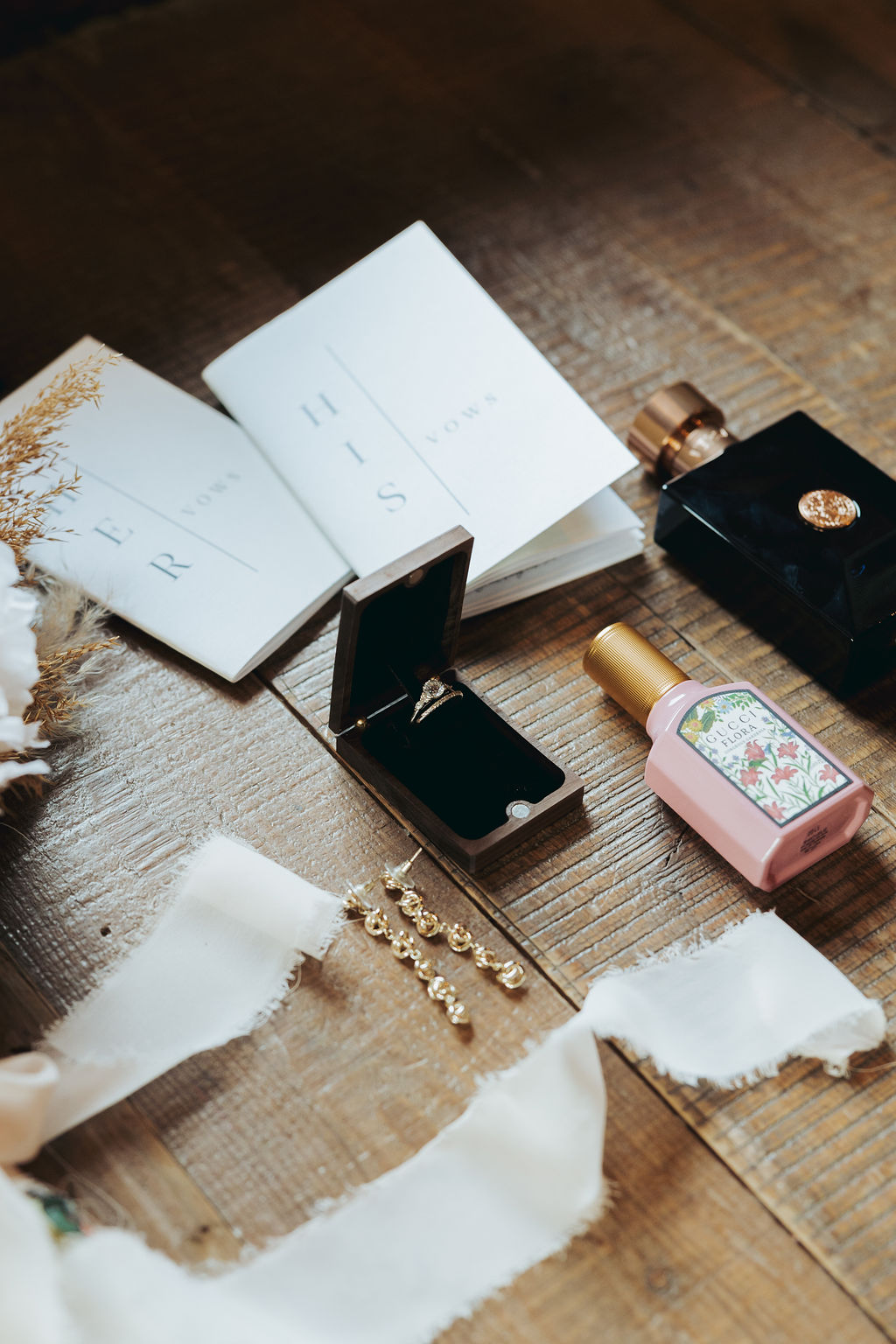 bride and groom vows and rings and details with cologne