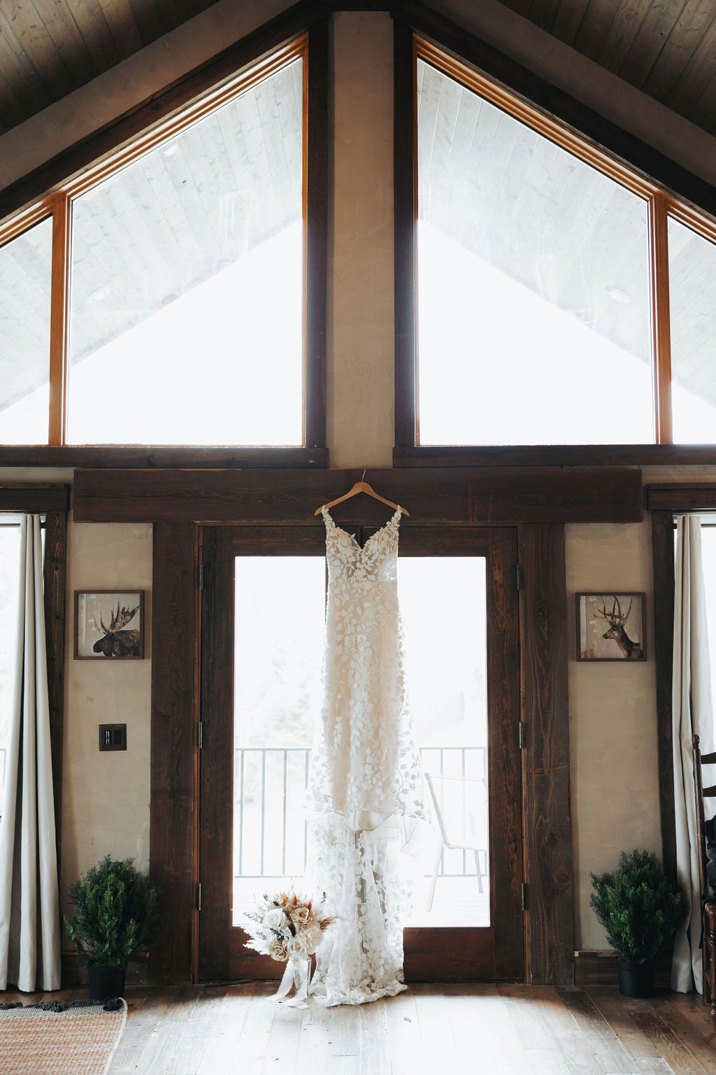 bridal wedding dress hanging up in rustic cabin