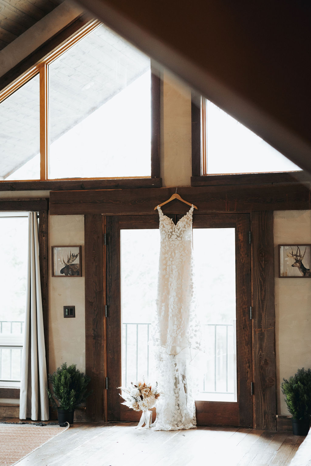 bridal wedding dress hanging up in rustic cabin