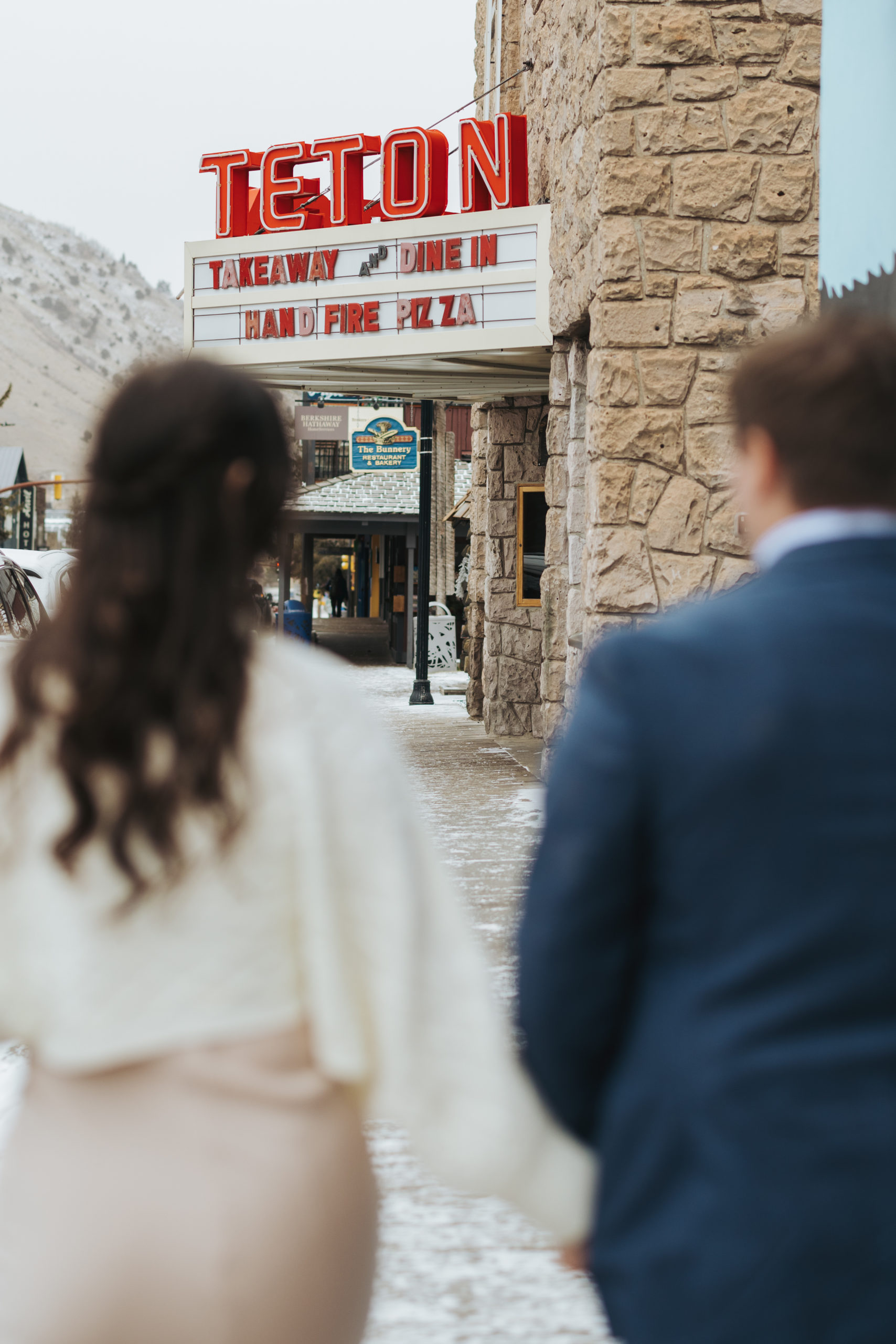 bride and groom walking in downtown area