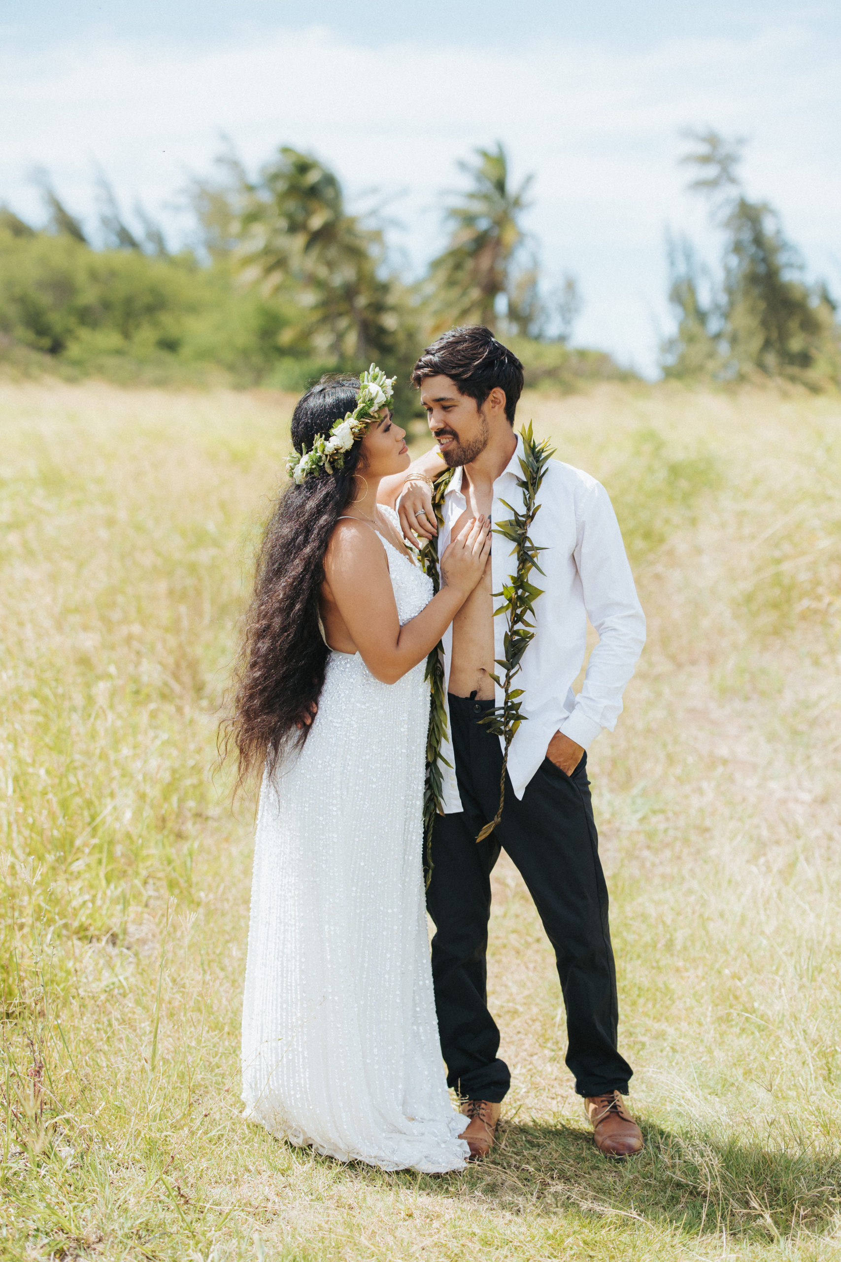 bride and groom standing in a field elopement portrait in hawaii