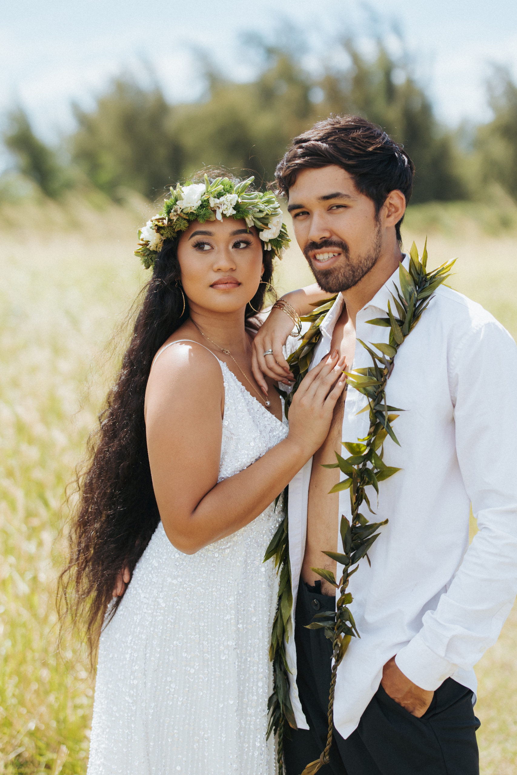 bride and groom standing in a field couple portrait in hawaii