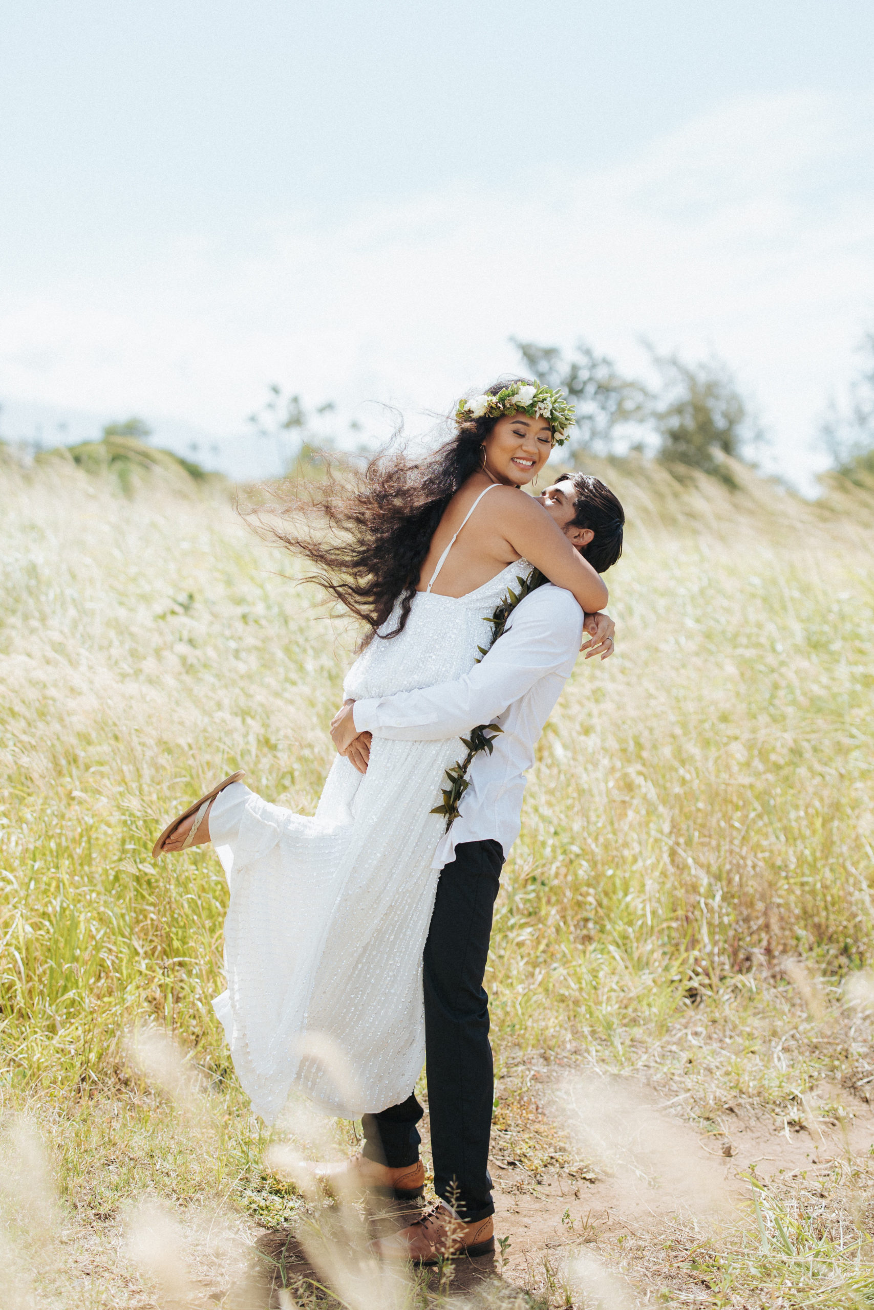 bride and groom standing in a field elopement portrait in maui hawaii