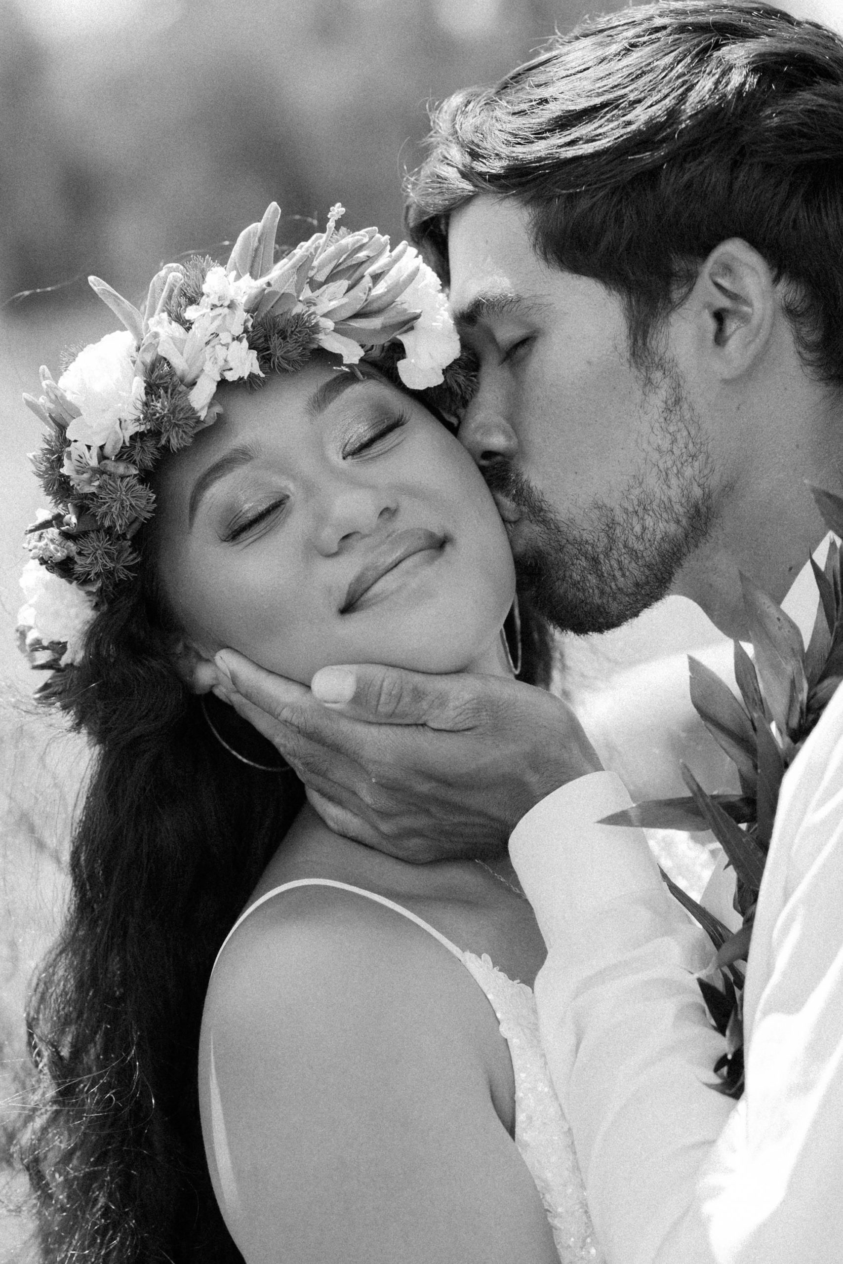 bride and groom kissing in a field couple portrait in hawaii