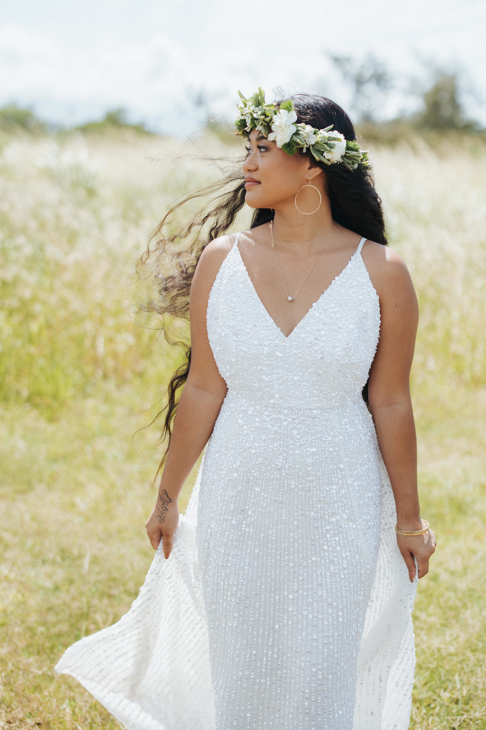 bride dancing in a field wearing a glitter wedding dress