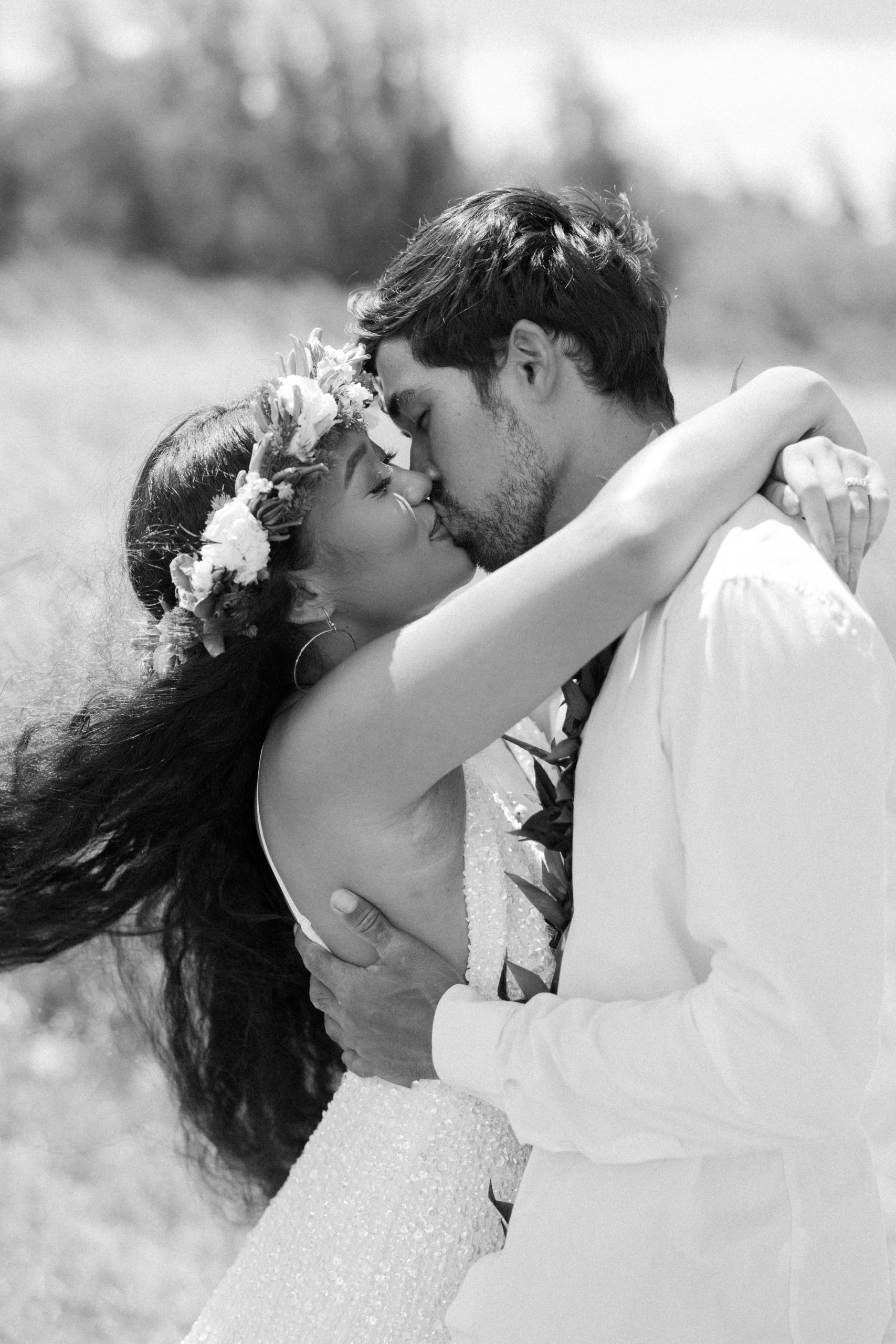 bride and groom kissing in a field couple portrait in hawaii