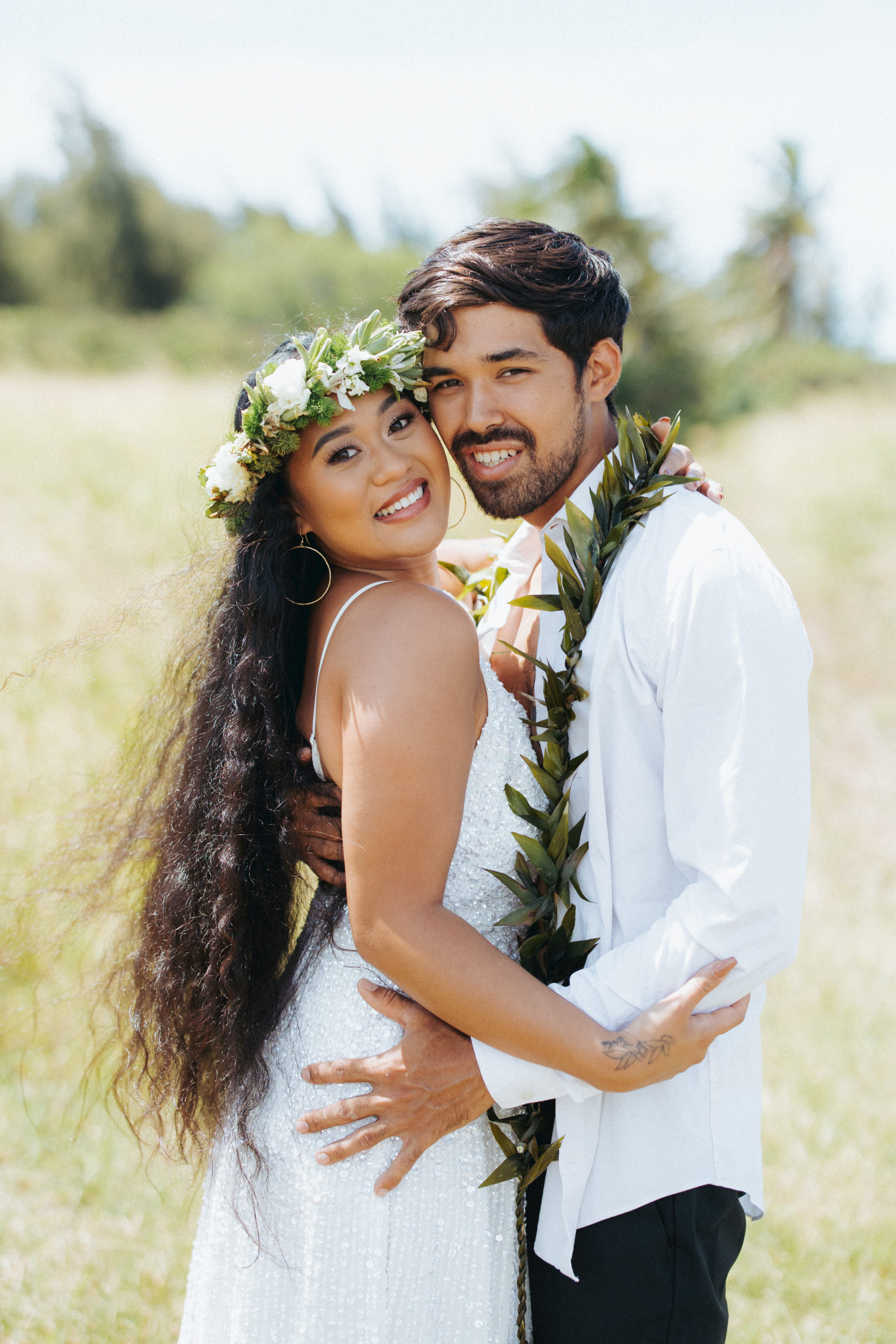 bride and groom standing in a field couple portrait in hawaii