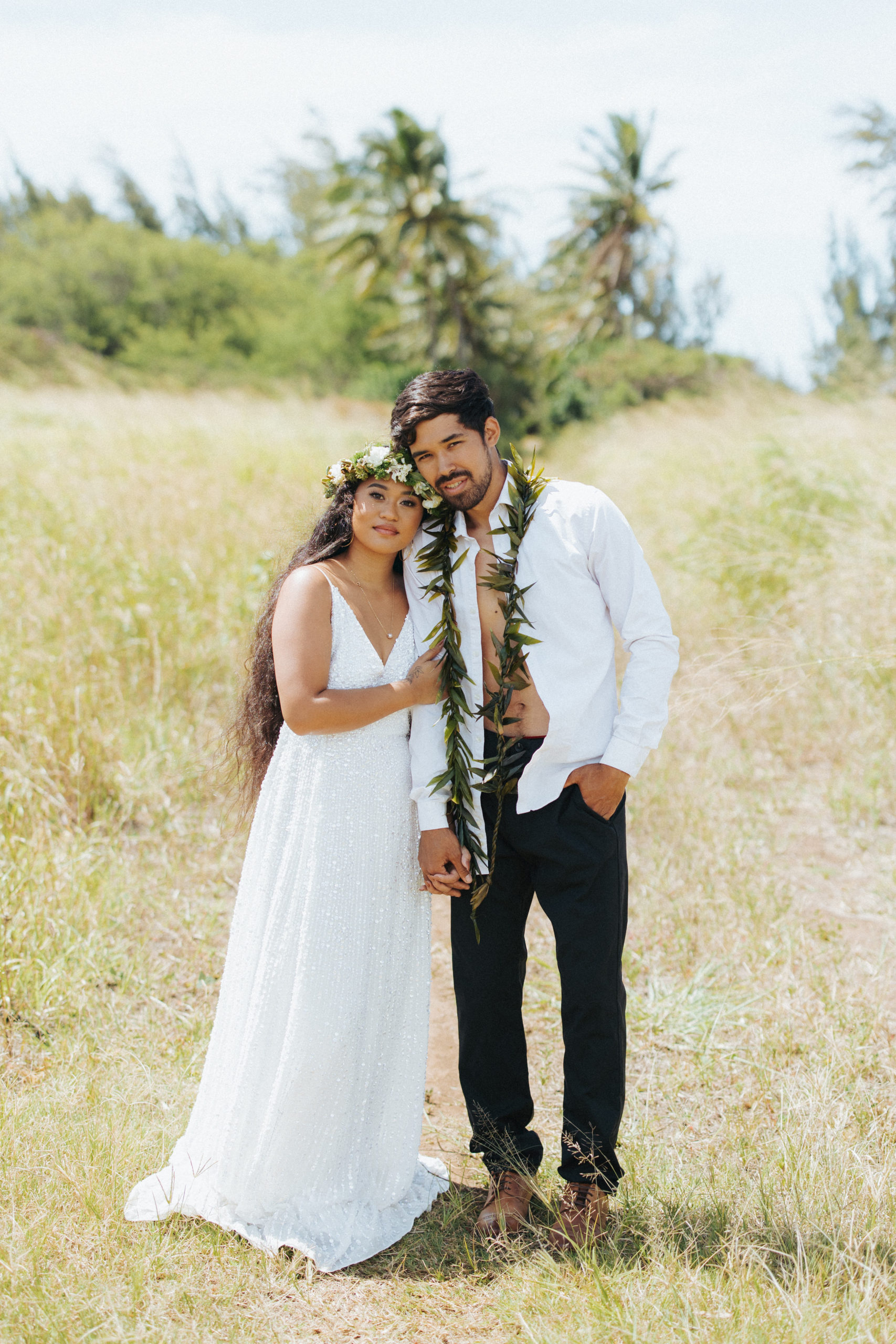 bride and groom standing in a field couple portrait in maui hawaii