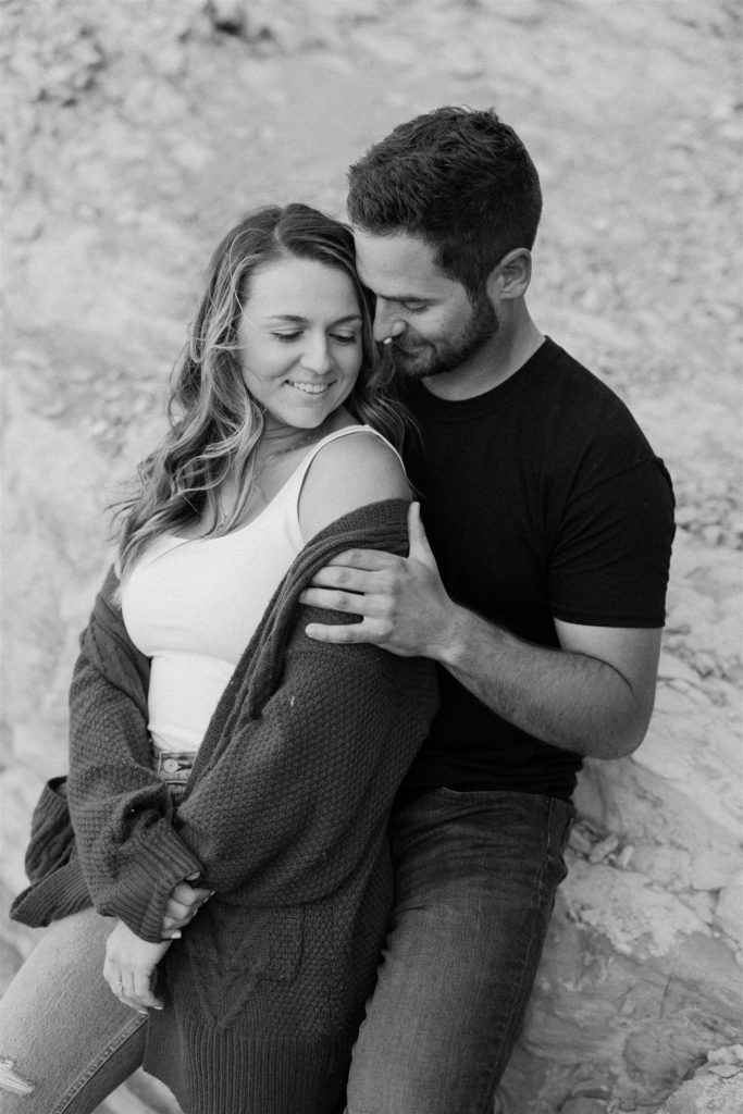 Couple hugging in engagement photos on the beach in santa barbara