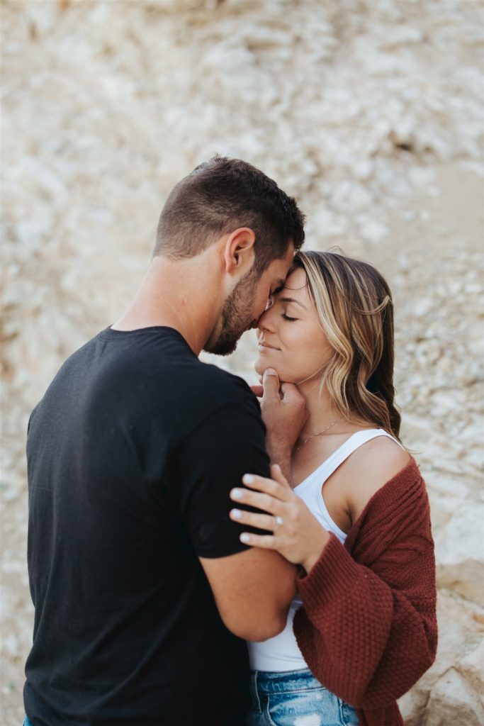 Couple hugging in engagement photos on the beach in santa barbara