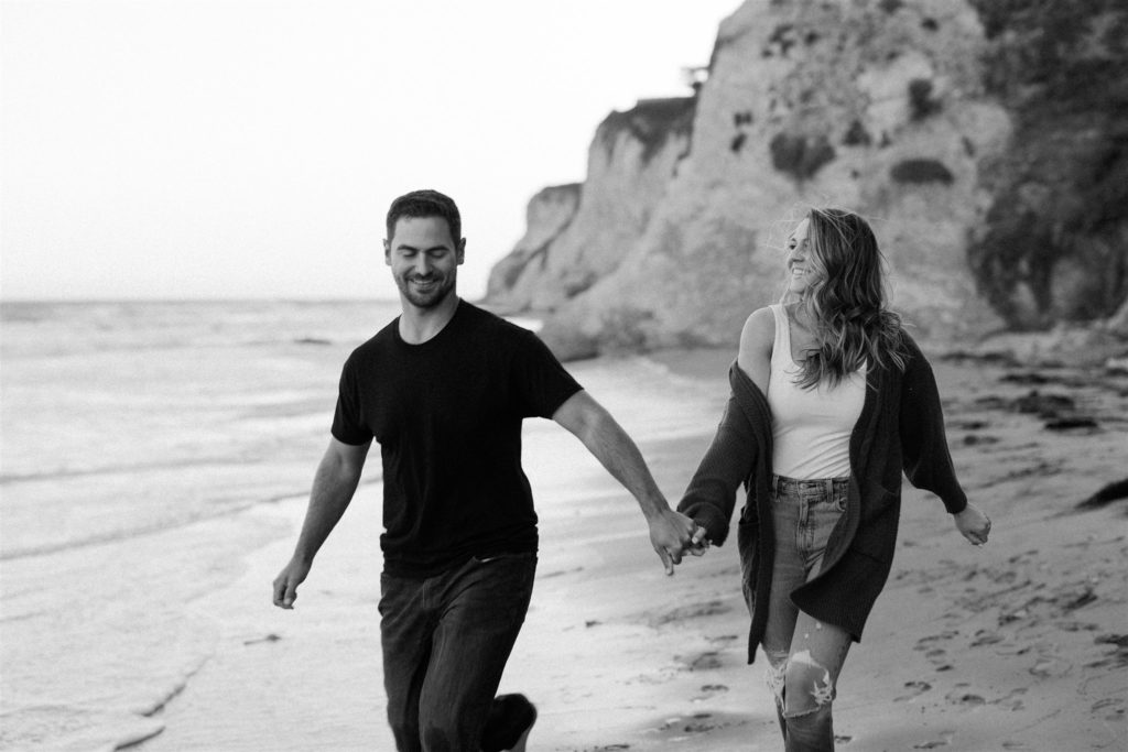 Couple walking on the beach in santa barbara