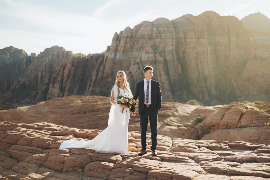 bride and groom elopement portraits walking during an adventure session at Snow Canyon