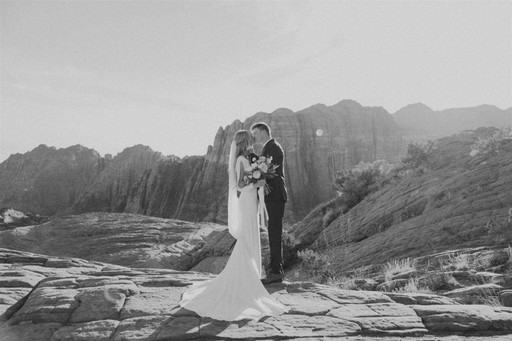 black and white image of bride and groom during an adventure session at Snow Canyon