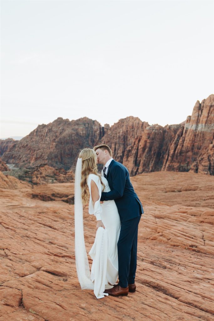 bride and groom kissing during an adventure session at Snow Canyon