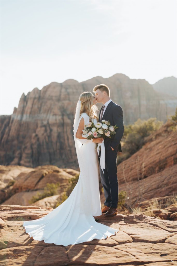 bride and groom kissing during an adventure session at Snow Canyon