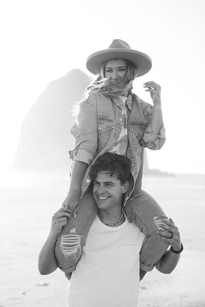 woman on man's shoulders at the beach