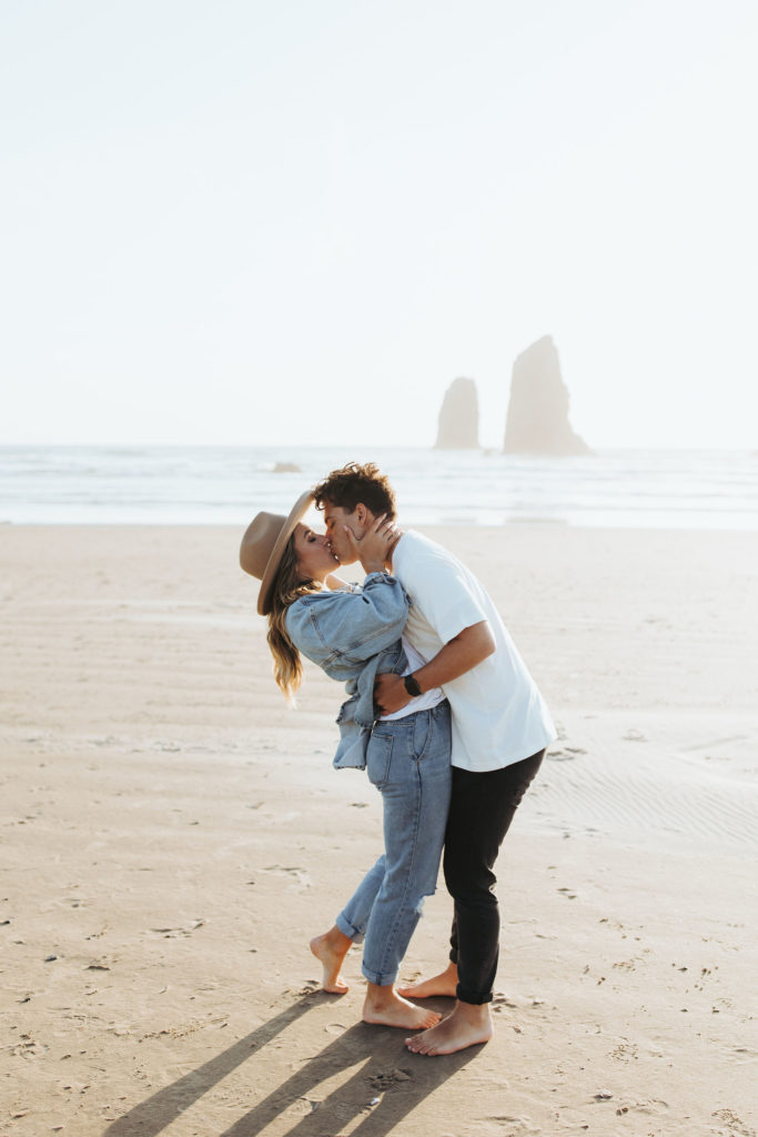 couple kissing on the beach in in Cannon Beach Oregon