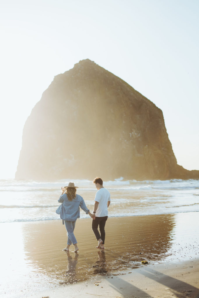 couple walking on the beach in Cannon Beach Oregon