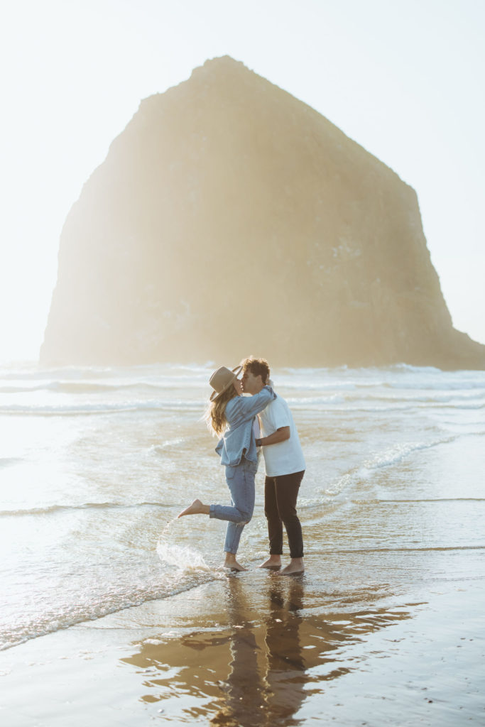 couple kissing on the beach in Cannon Beach Oregon