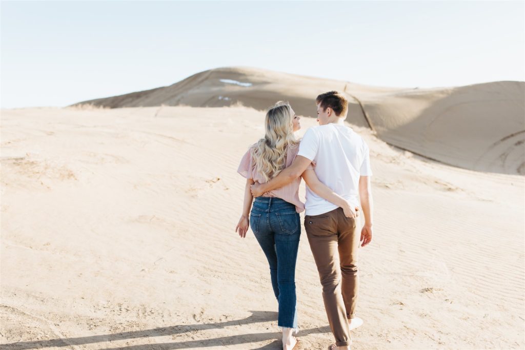 Couple walking on the sand dune