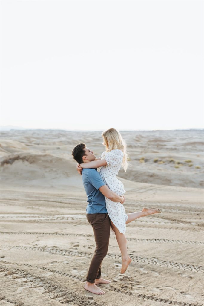 Couple hugging on sand dune