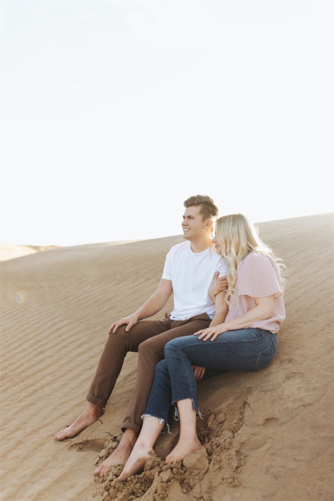 Couple sitting on the sand dune