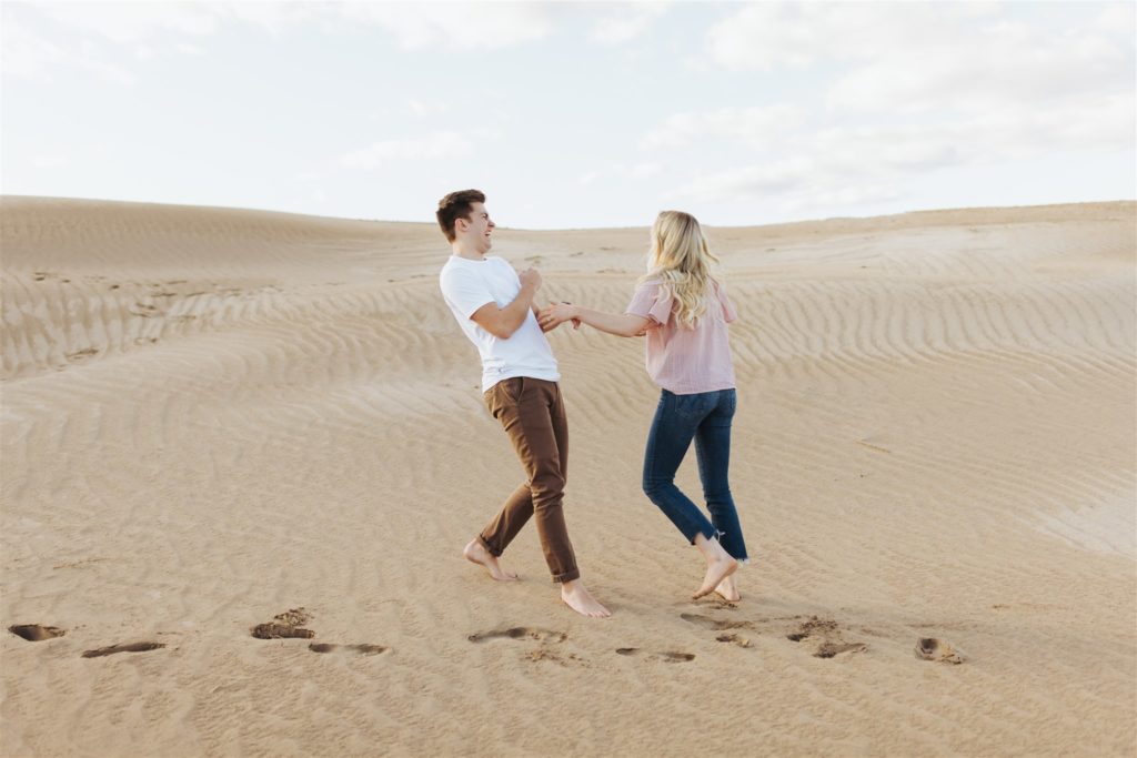 Couple walking on the sand dune