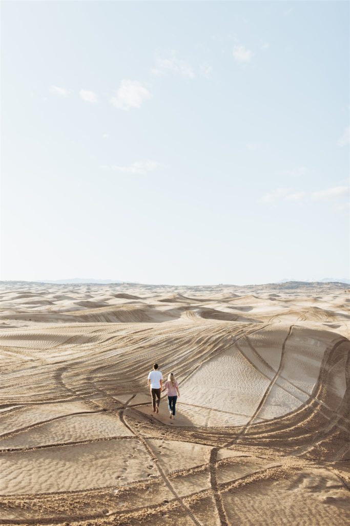 Couple running on the sand dune