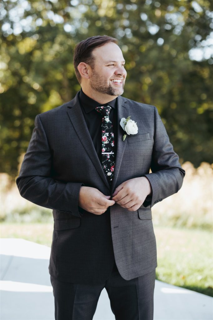 groom in black suits in wedding venue