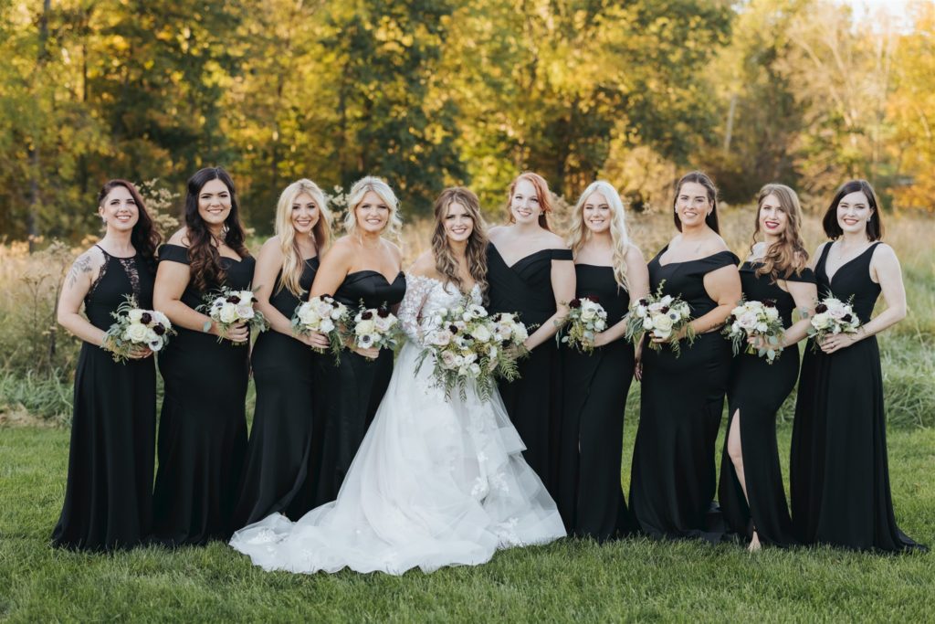 bride with lace wedding dress and bridesmaids