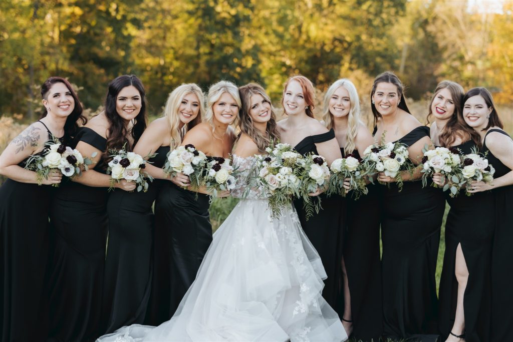 bride with lace wedding dress and bridesmaids