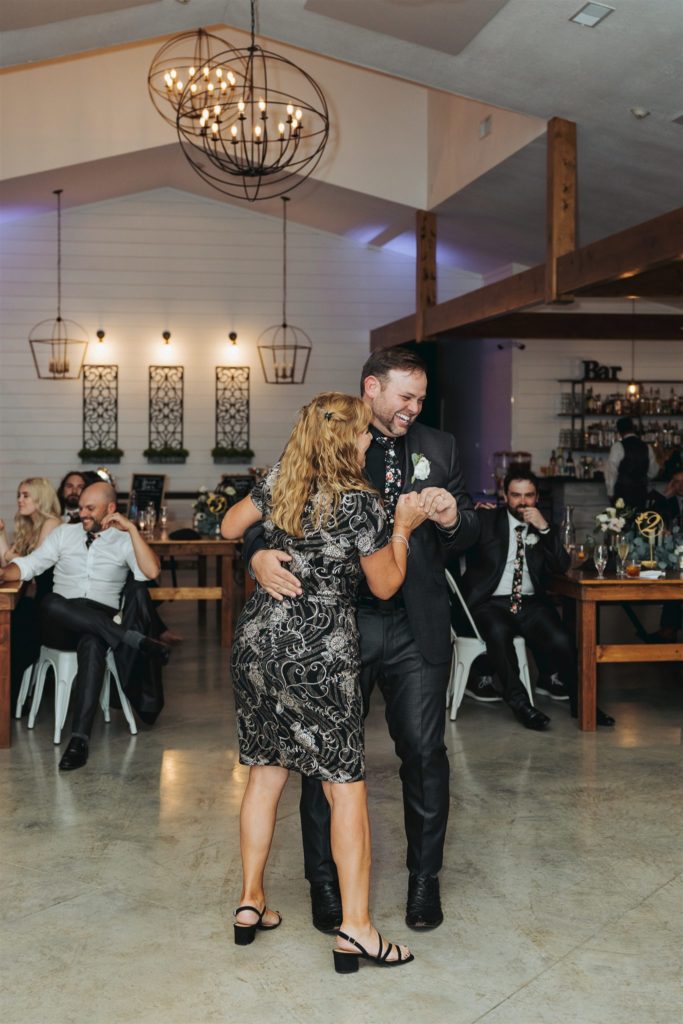 groom dancing with mom at wedding reception