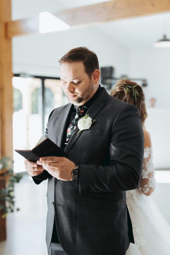 bride and groom reading letters to each other back to back