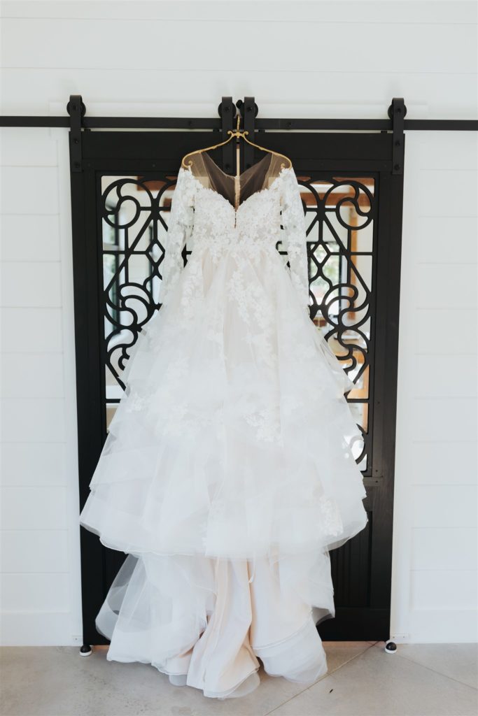 wedding dress hanging on a door