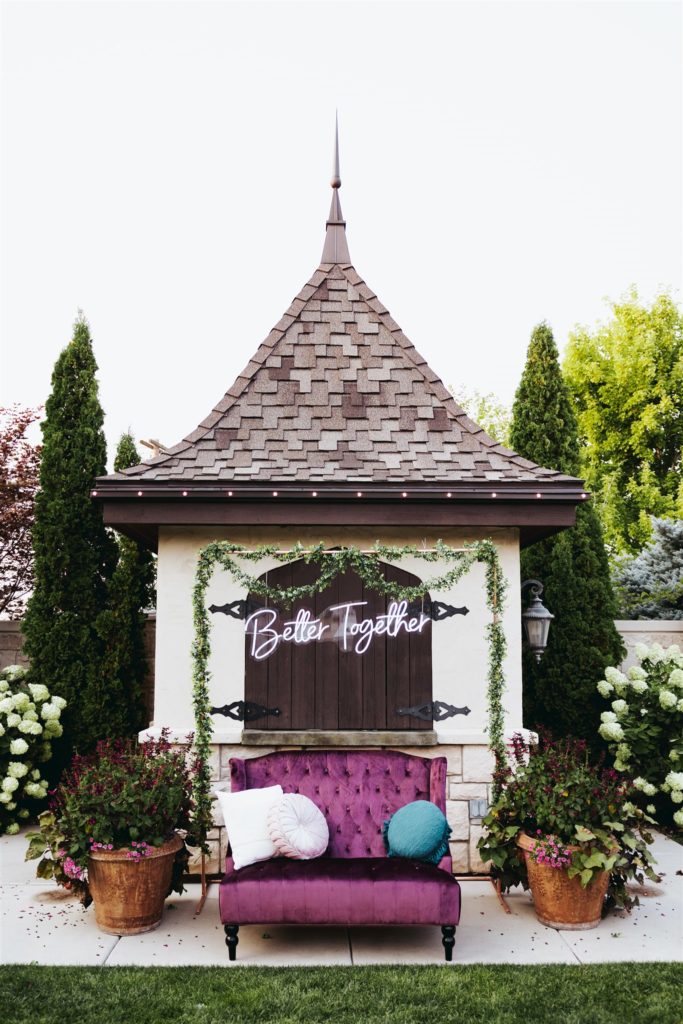 wedding photobooth backdrop with purple velvet couch at Le Jardin wedding venue in Draper Utah