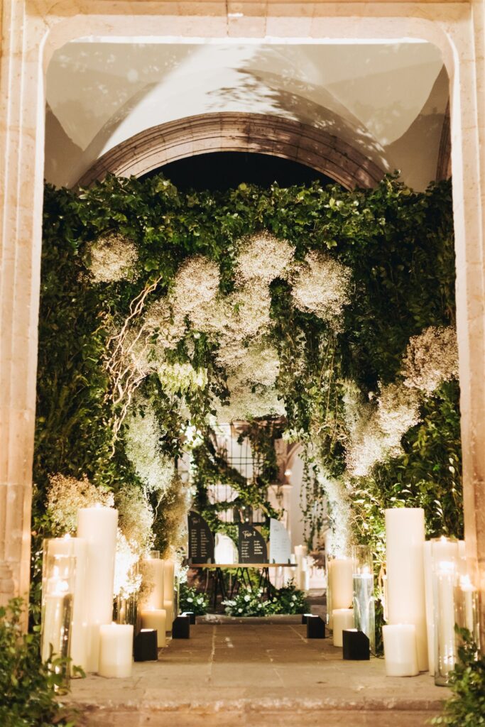floral arch at wedding reception with candles