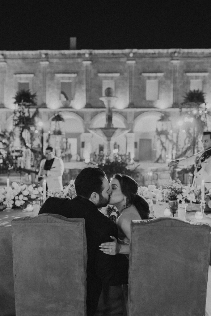 bride and groom kissing at wedding reception in Morelia Mexico