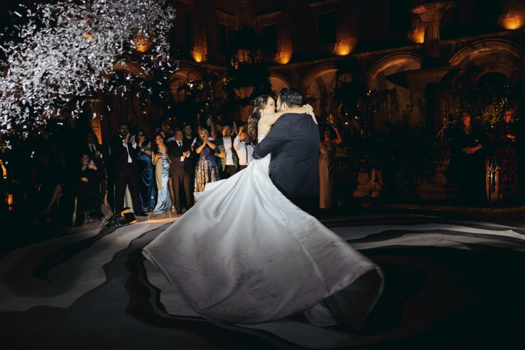 bride and groom dancing at wedding reception with confetti