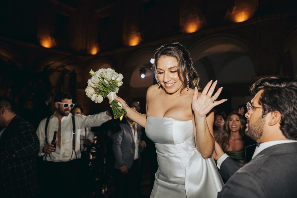 bride bouquet toss at wedding reception
