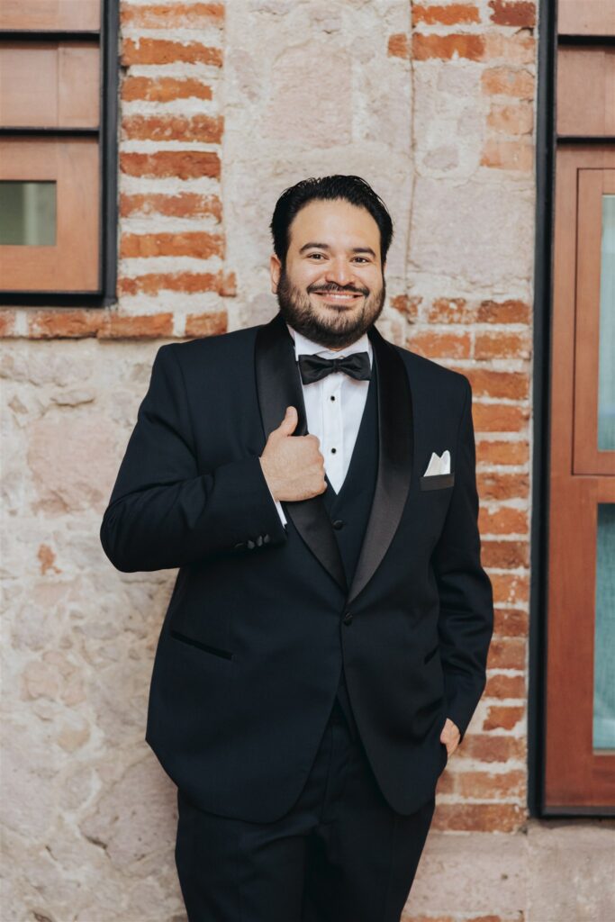 groom portrait in black suit with black tie