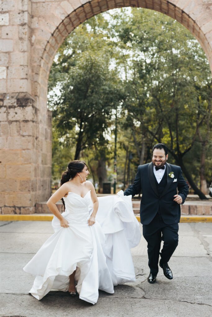 bride and groom wedding portraits under architectural arch in Morelia Mexico