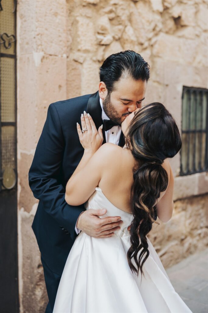 bride and groom kissing wedding portraits