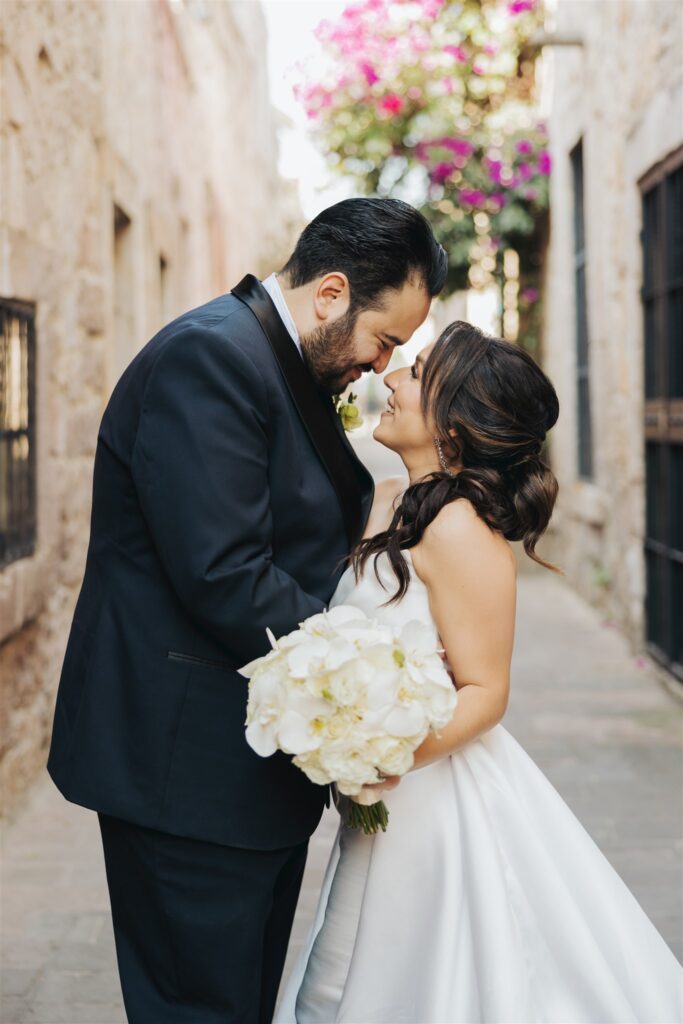 bride and groom kissing wedding portraits
